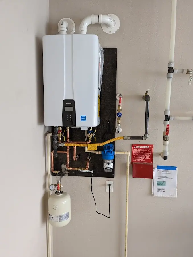 Professional plumber installing copper piping in a Maple Heights home